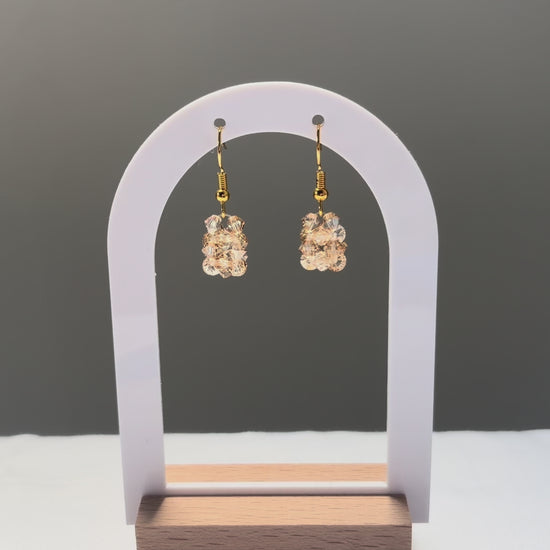 A video of the Solid Earrings Champagne dangling in the sunlight, sparkling beautifully. 