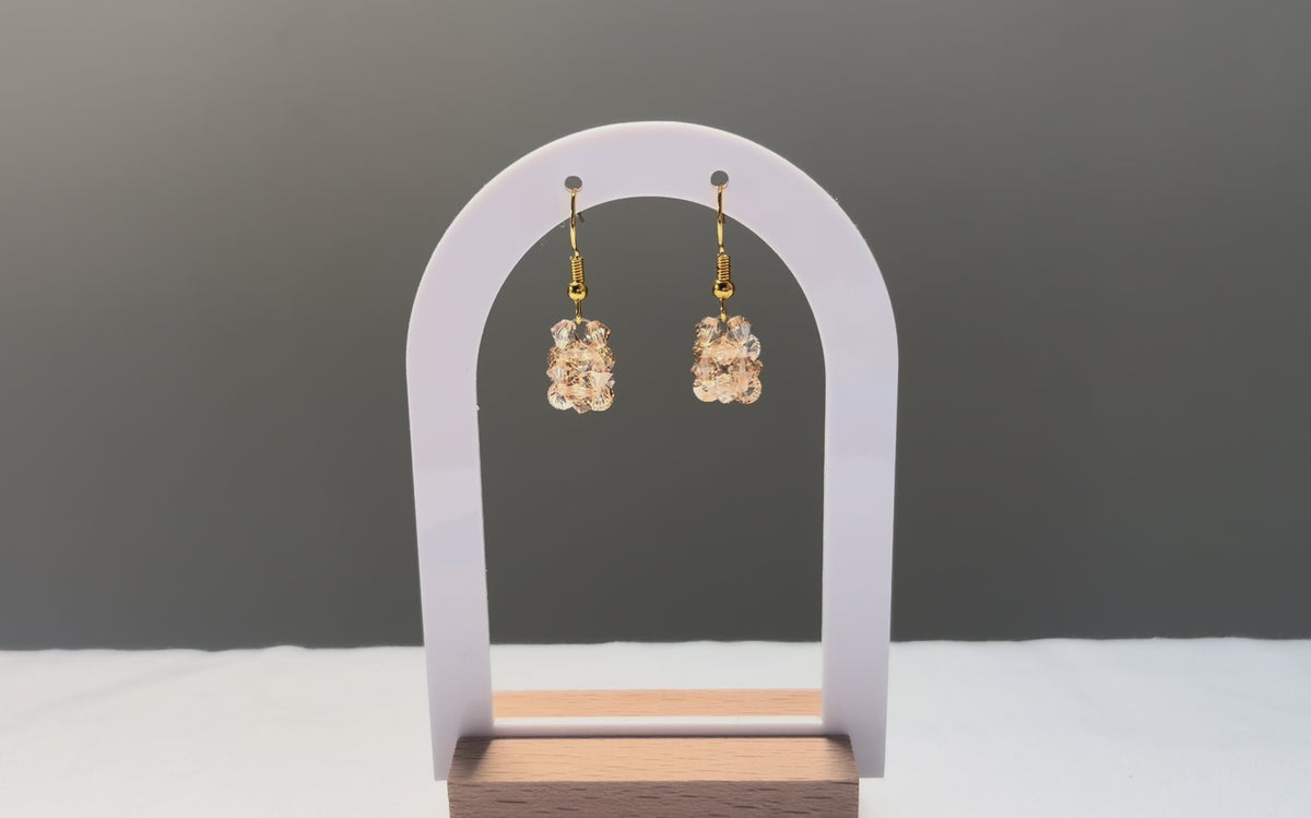 A video of the Solid Earrings Champagne dangling in the sunlight, sparkling beautifully. 