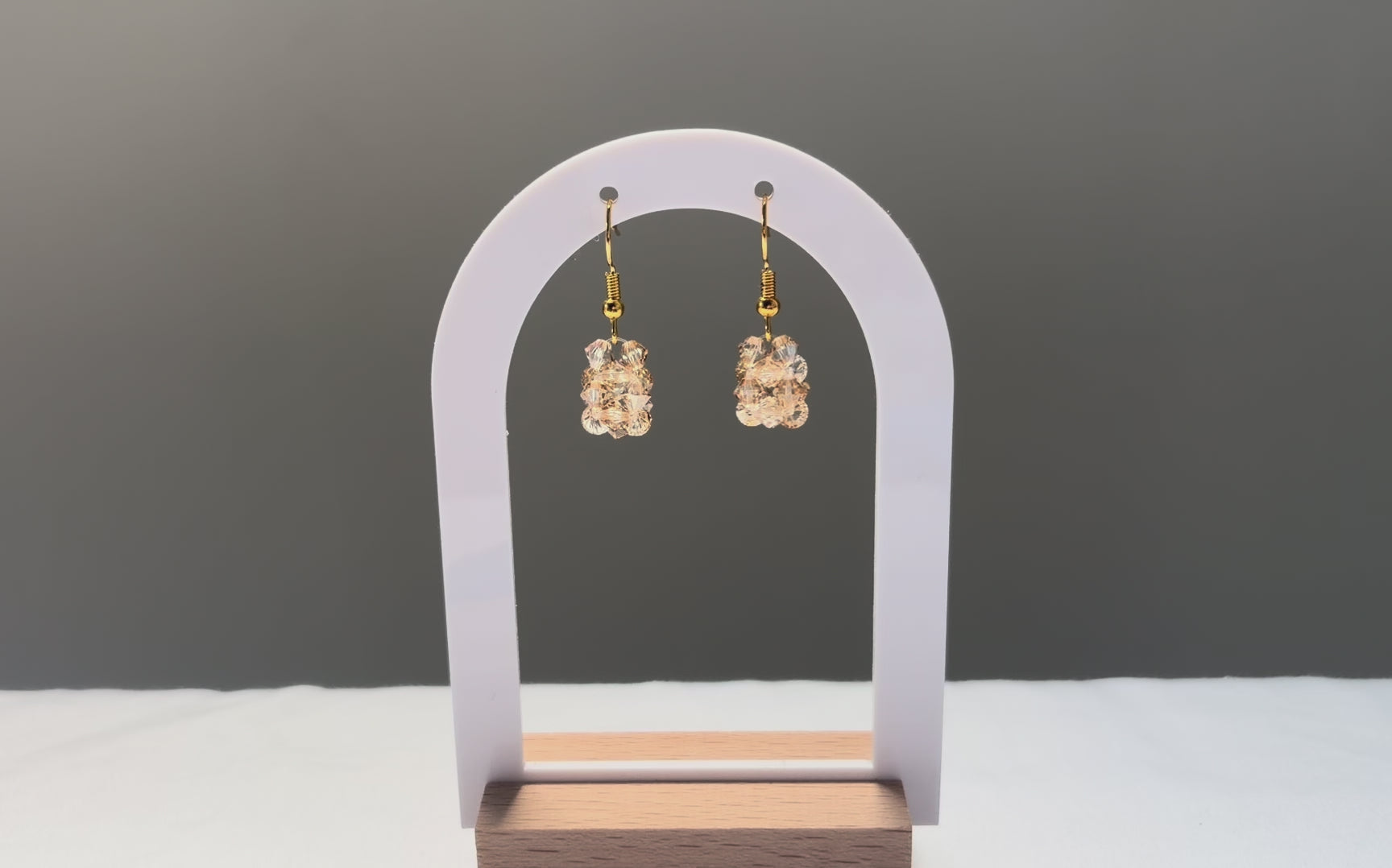 A video of the Solid Earrings Champagne dangling in the sunlight, sparkling beautifully. 