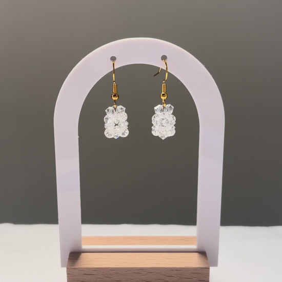 A video of the Solid Earrings Iced dangling in the sunlight, sparkling beautifully. 