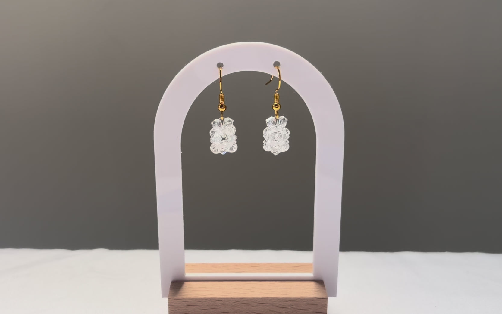 A video of the Solid Earrings Iced dangling in the sunlight, sparkling beautifully. 