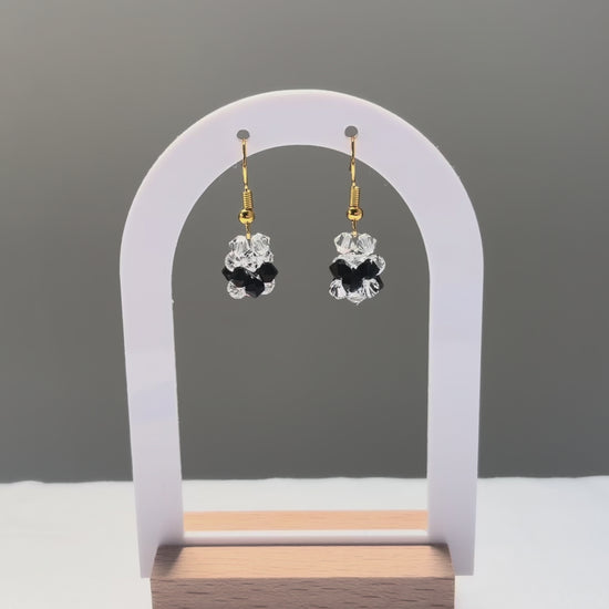 A video of the V Earrings Bossanova dangling in the sunlight, sparkling beautifully. 
