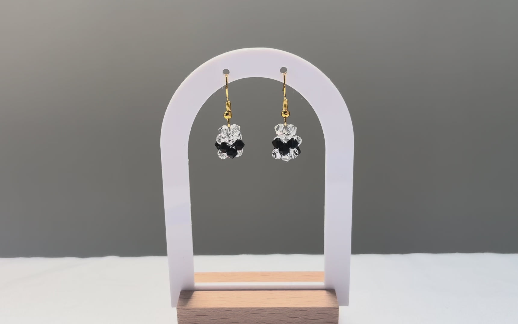 A video of the V Earrings Bossanova dangling in the sunlight, sparkling beautifully. 
