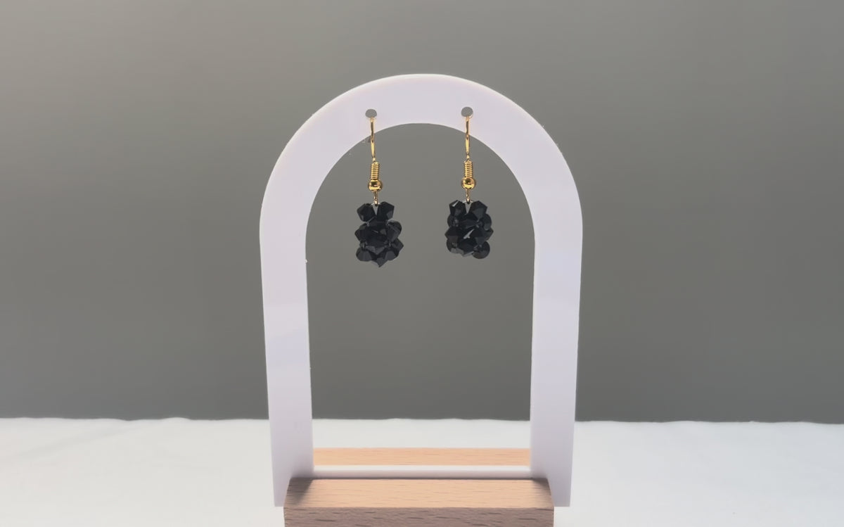 A video of the Solid Earrings Caviar dangling in the sunlight, sparkling beautifully. 